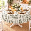 Fata de masa rotunda 140cm cu peisaje vintage si vegetatie verde pe fundal crem, pe masa decorata cu vesela alba