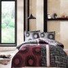 Lenjerie de pat TAC Lionel Bordo, bumbac 100% satinat, design cercuri bordo și gri, fundal negru.