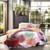 Lenjerie de pat dublu din bumbac ranforce cu model abstract de cercuri colorate în nuanțe de portocaliu, mov, roz și verde pe fundal alb