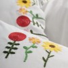 Lenjerie de pat Mina cu broderie florală în culori vii pe fundal alb și cearșafuri roz intens, bumbac ranforce, marca CottonBox.