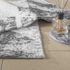 Set de 2 covorașe de baie Tac PasPas Pyra gri model geometric modern, plasate pe podea de baie alături de papuci