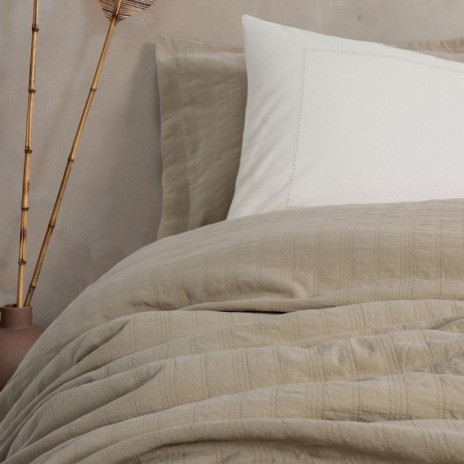 Set Vilo Bej – cuvertură pique texturată și fețe pernă brodate, expus pe pat în decor natural